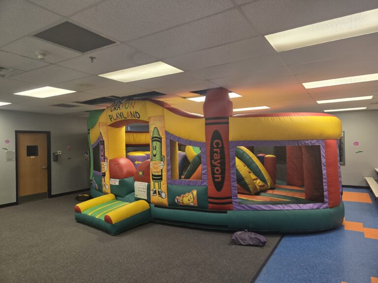 Indoor crayon-themed inflatable playland set up for a daycare event rental in Omaha