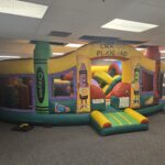 Colorful Crayon Playland indoor inflatable rental set up by Jumpers4You – Omaha bounce house delivery