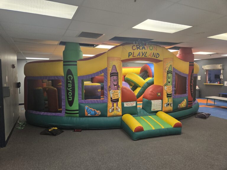 Colorful Crayon Playland indoor inflatable rental set up by Jumpers4You – Omaha bounce house delivery