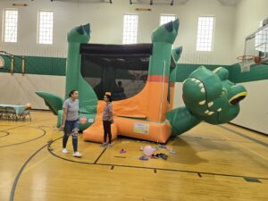 Crocodile bounce house setup in a gym by Jumpers4You – Omaha bounce house delivery