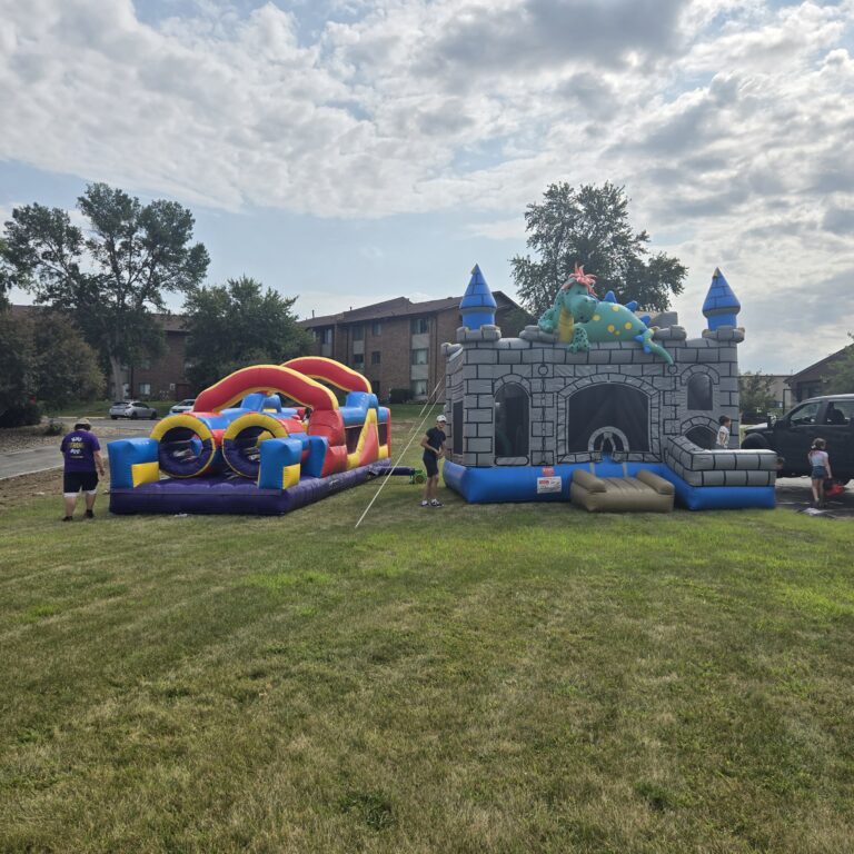 HOA and Block Party Rentals Omaha – obstacle course and dragon castle bounce house at a community event