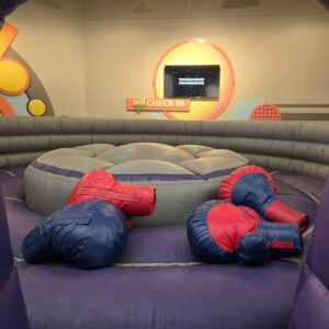 Giant inflatable boxing gloves on the arena floor – Jumpers4You Omaha bounce house delivery setup