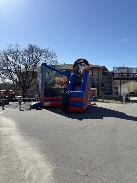 HOA and Block Party Rentals Omaha – space-themed inflatable bounce house and slide at a community event