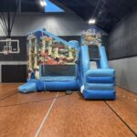 Indoor bounce house setup in Omaha gymnasium with ocean theme combo unit – Omaha bounce house delivery