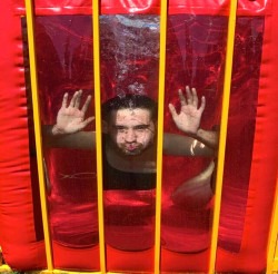 Participant underwater in a dunk tank during a rental event – a fun example of what to expect on event day with Jumpers4You.