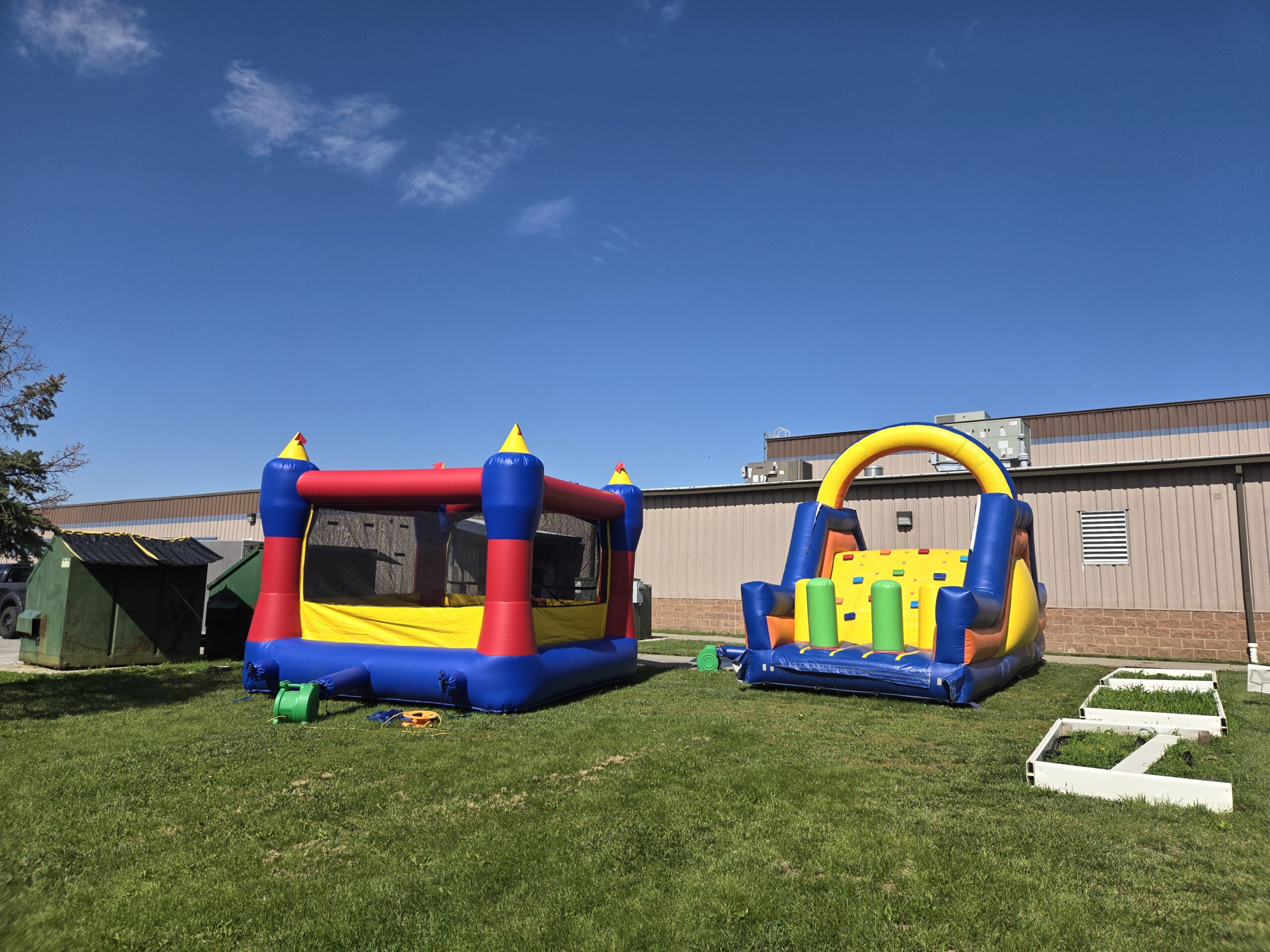 Gretna Party Rentals represented by a colorful bounce house, toddler playland and yard games set up outdoors