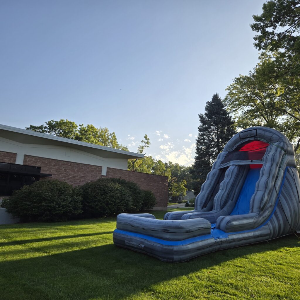 Gray marbled inflatable water slide set up on a residential lawn