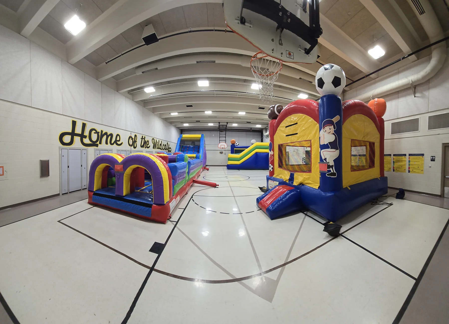 Indoor party rentals Omaha school gym setup with multiple Jumpers4You inflatables