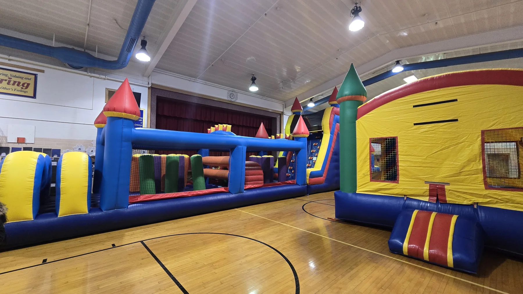 Winter event rentals Omaha school gym with obstacle course and bounce house