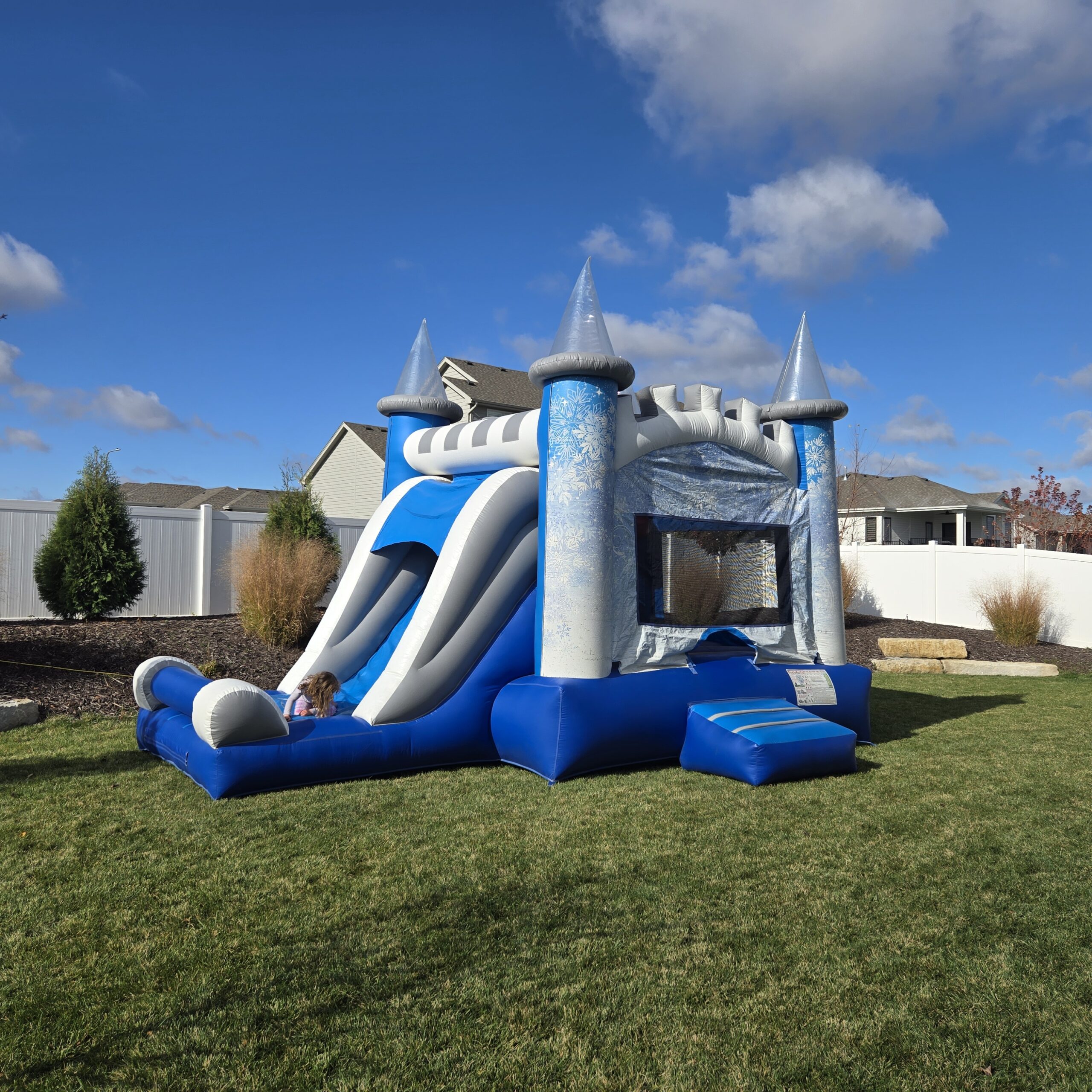 Birthday Party Rentals Omaha blue castle combo set up in a family backyard